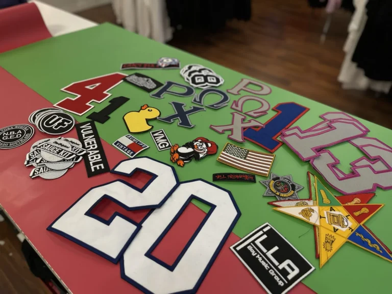 Assorted letter, number, flag and logo patches on a table