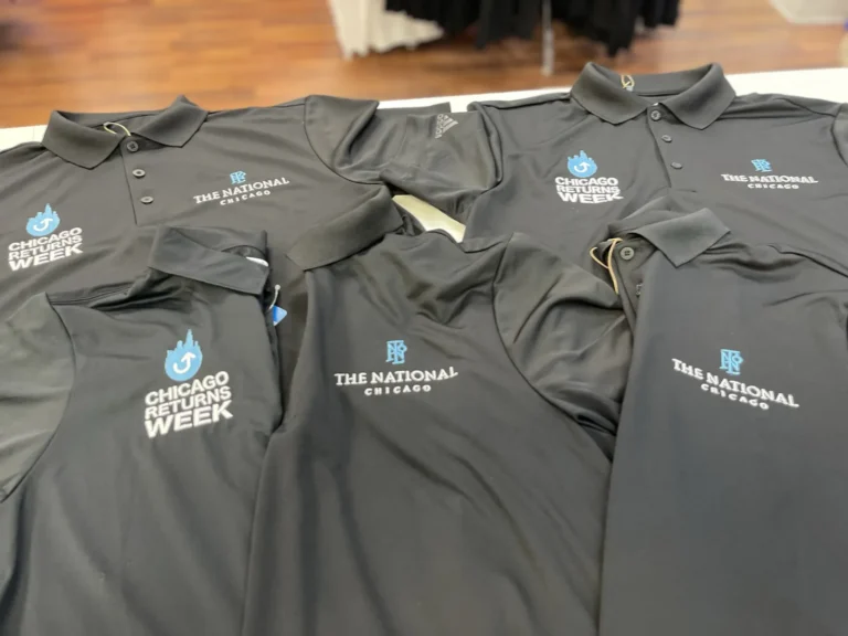 Gray polo shirts with Chicago Returns Week and The National Chicago logos