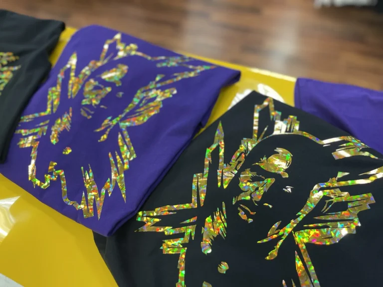 Purple and black shirts with shimmering multicolor graphic designs