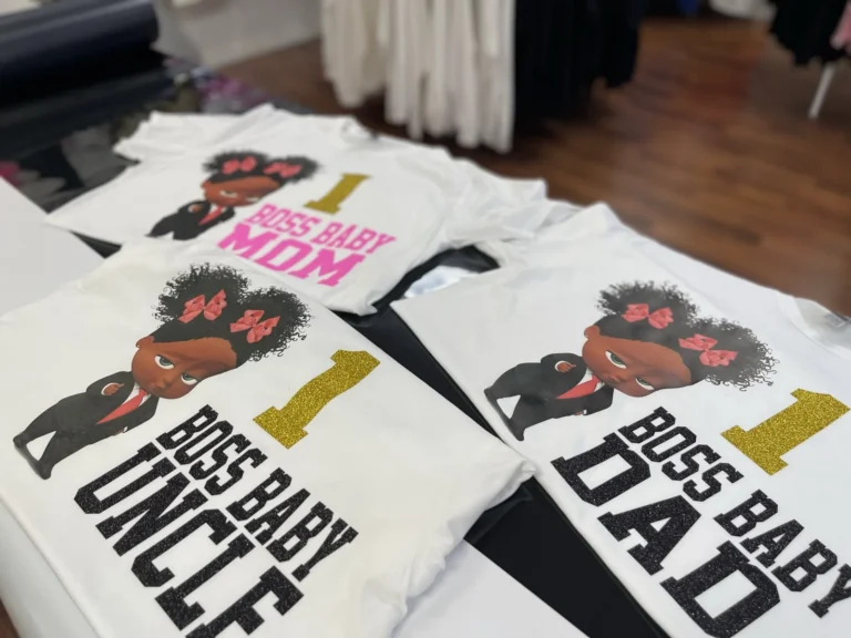 Three white birthday shirts with coordinated cartoon designs and family role lettering