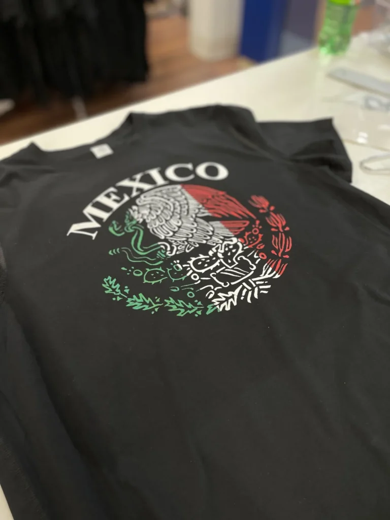 Black shirt with a red white and green Mexico eagle design