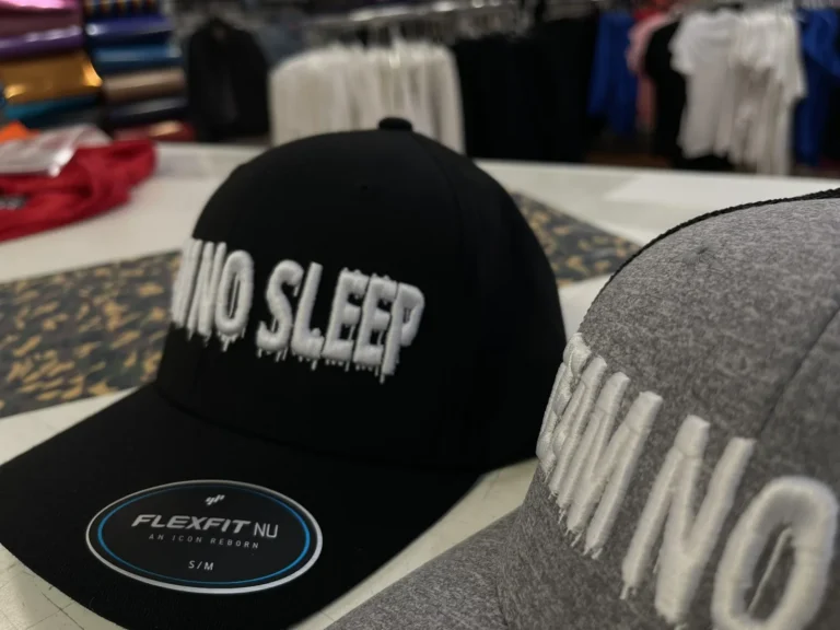 Black and gray caps with raised white lettering