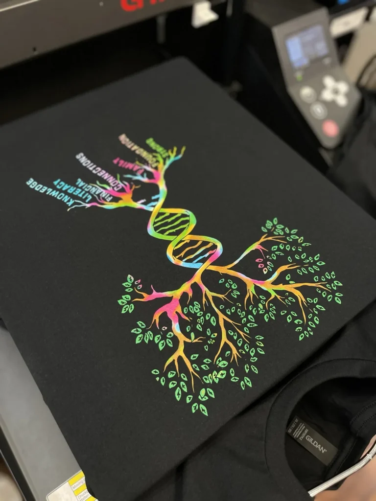 Black shirt with a rainbow tree and DNA inspired graphic