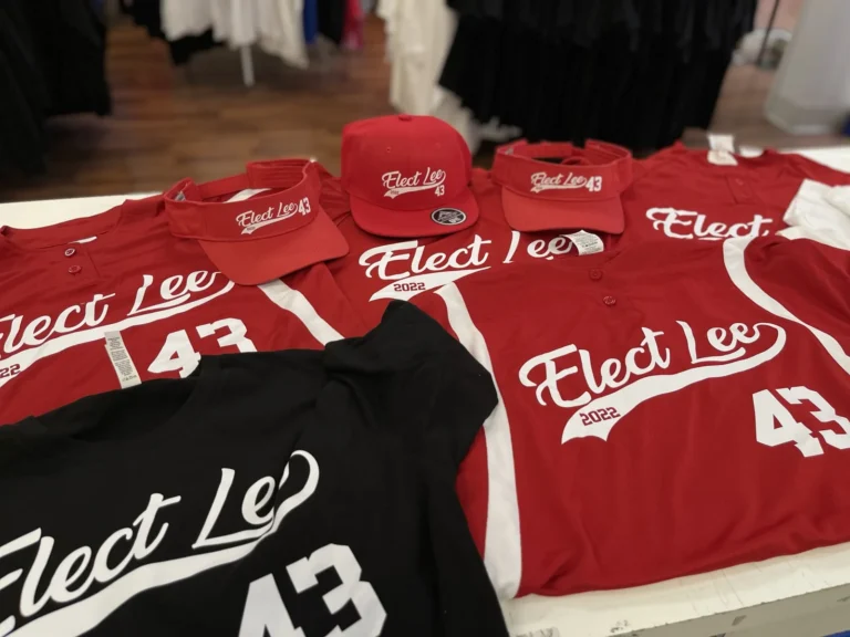 Matching red shirts, caps and visors with white Elect Lee designs