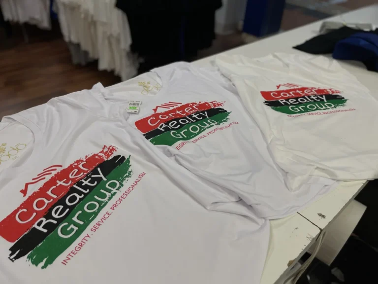 White shirts with red, black and green Carter Realty Group logos