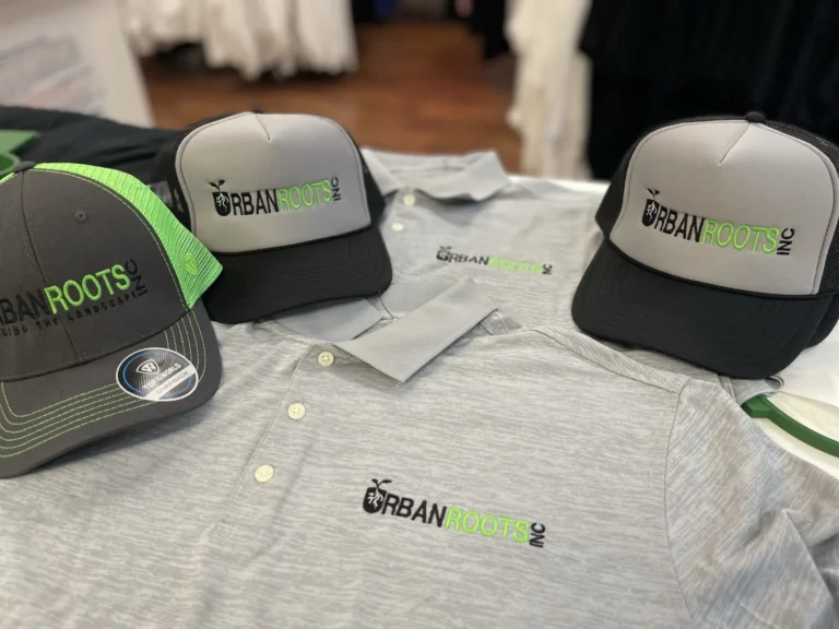 Gray caps and polo shirts with green and black Urban Roots logos